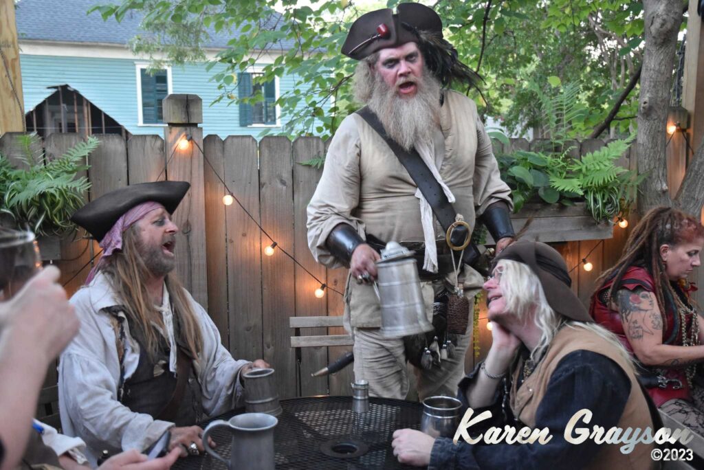 Pirates singing shanties in the Brick Store Pub garden. PiratePalooza 19. Photo by Karen Grayson, copyright 2023